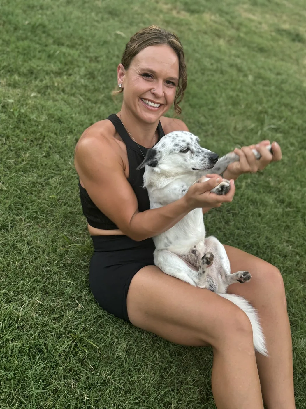 MacKenzie Carter with her dog Paco on the grass