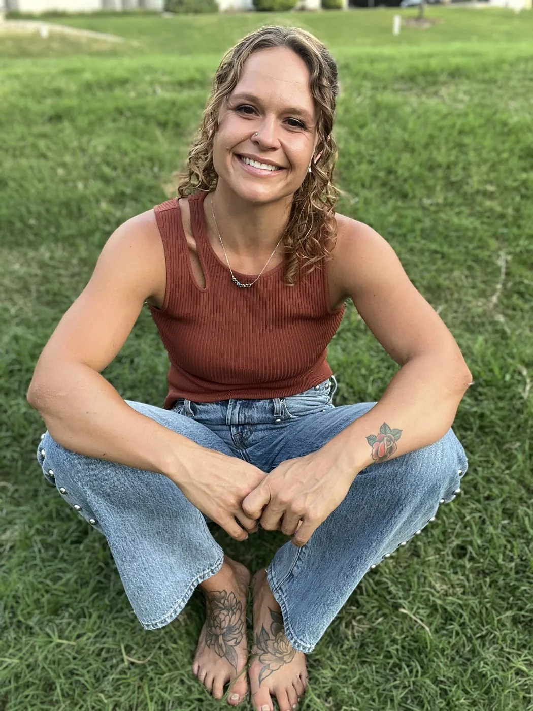 MacKenzie Carter smiling, seated on the grass