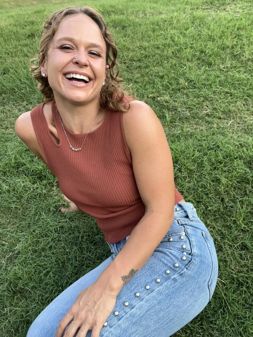 MacKenzie Carter laughing on the grass